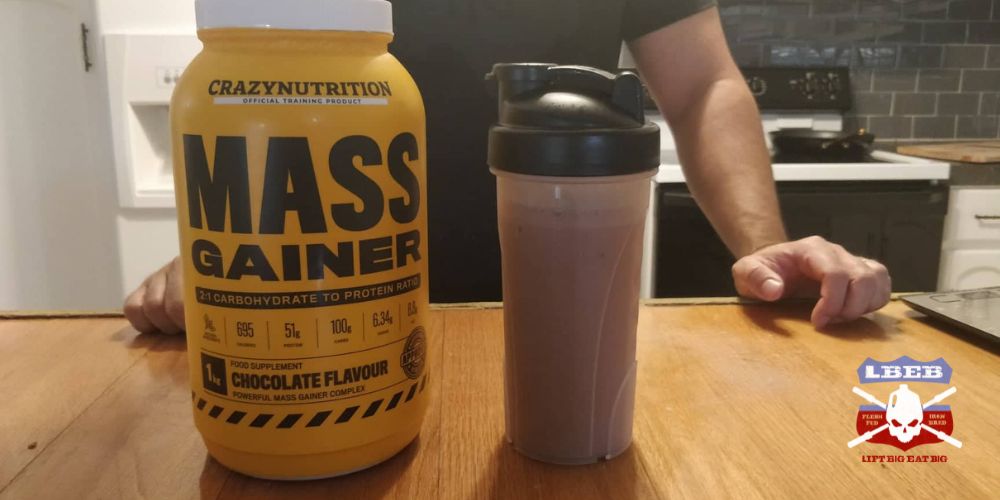 Mass gainer mixed in shaker bottle with tub next to it